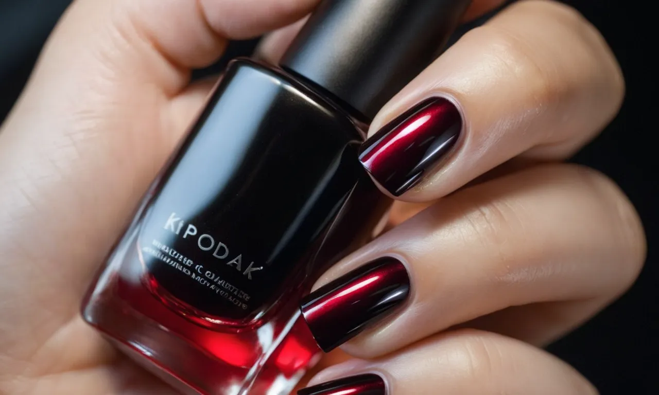 A close-up shot showcasing a hand with perfectly manicured black and red nails, the glossy finish reflecting light, exuding elegance and boldness.