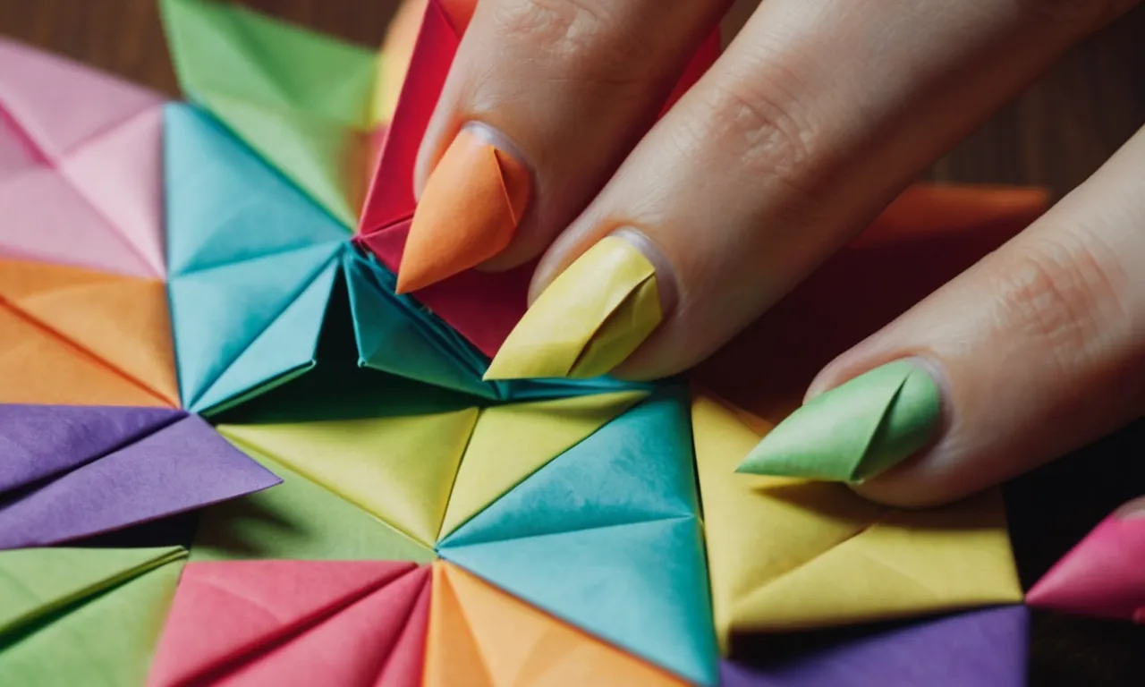 A close-up shot of a pair of hands delicately folding and creasing colorful origami paper into intricate nail shapes, showcasing the process of creating paper nails.