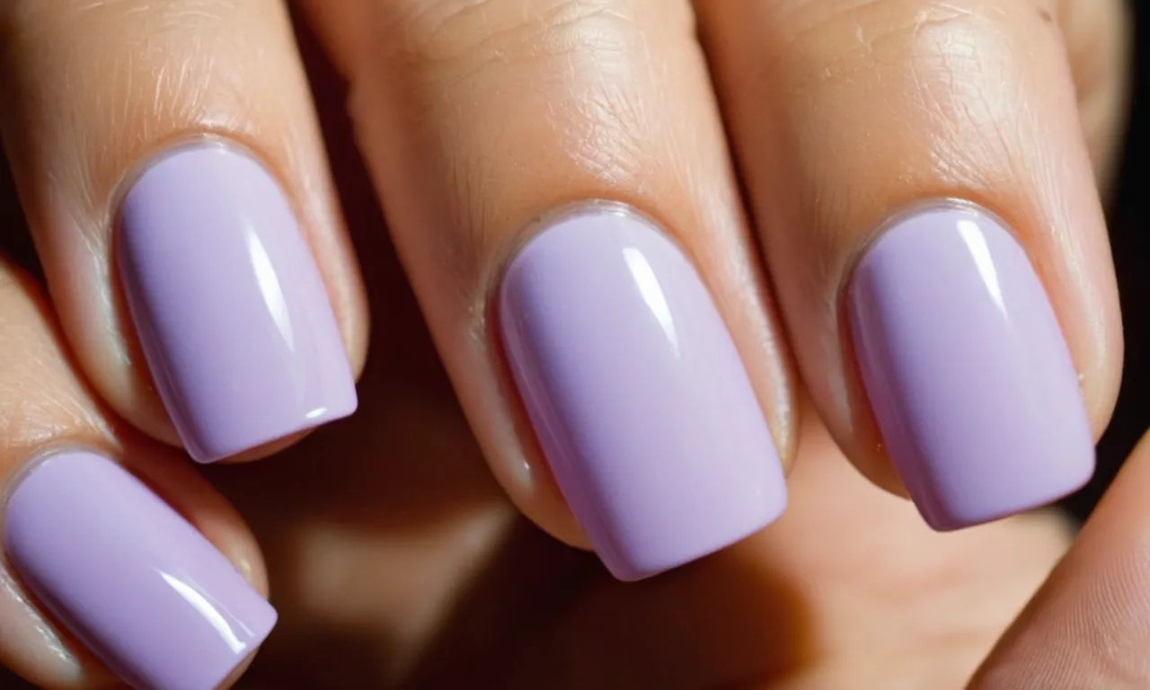 Close-up of a woman's hands flaunting perfectly manicured acrylic nails, appearing glossy and vibrant. The image exudes elegance, showcasing the importance of proper maintenance for maintaining healthy-looking nails.