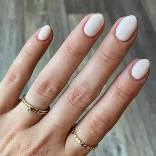 Modelones short oval-shaped press-on nails in white and pink, with adhesive tabs and glue